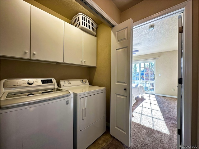 laundry room featuring dark carpet, cabinets, separate washer and dryer, and a textured ceiling