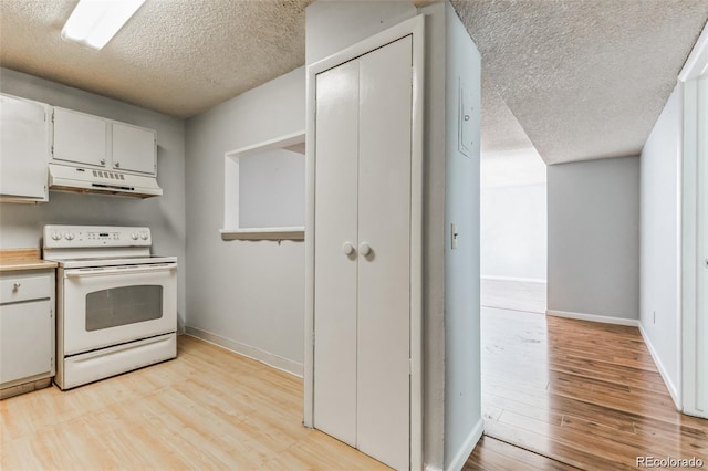 kitchen featuring white range with electric cooktop, light wood-type flooring, a textured ceiling, and white cabinets