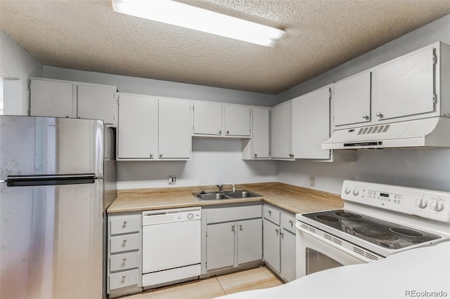 kitchen with white cabinetry, white appliances, sink, and a textured ceiling