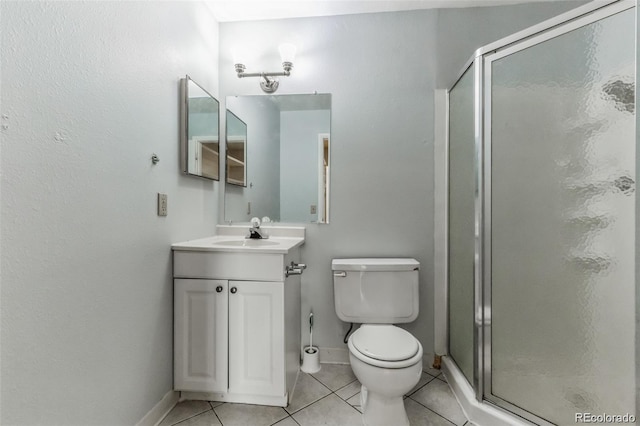 bathroom featuring vanity, toilet, an enclosed shower, and tile patterned flooring