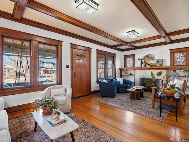 living area featuring hardwood / wood-style flooring, a fireplace, coffered ceiling, and a wealth of natural light