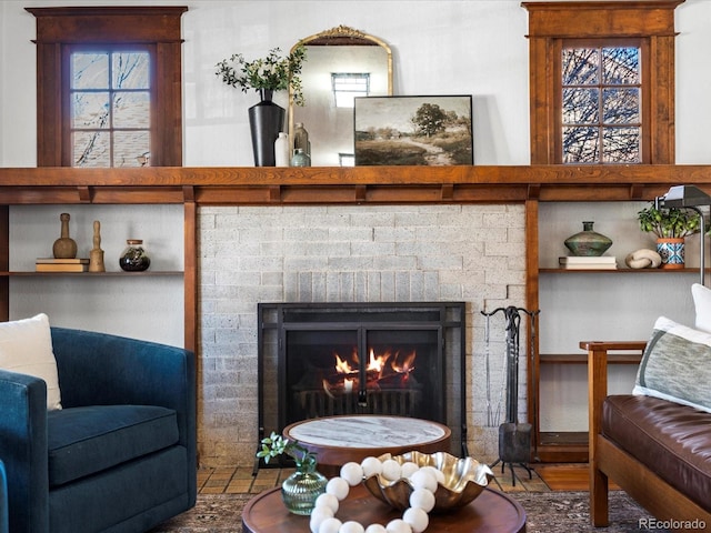 living room featuring built in shelves, a fireplace, and a wealth of natural light