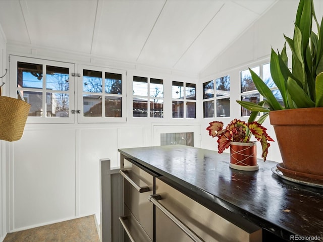 sunroom / solarium featuring lofted ceiling