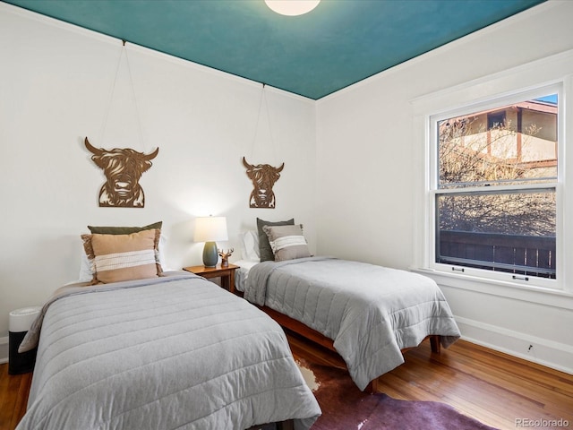 bedroom with wood finished floors and baseboards