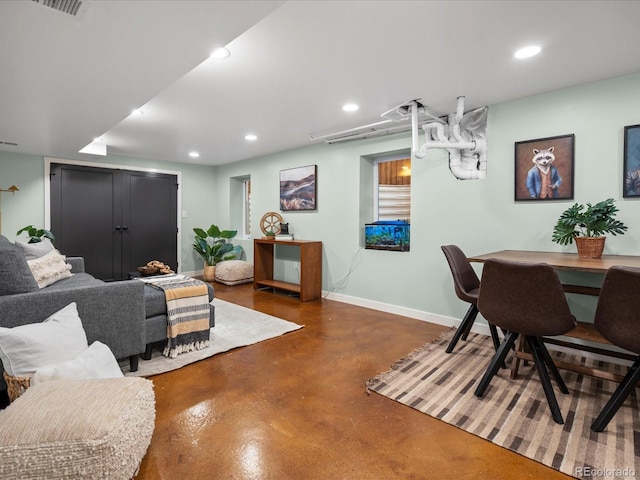 living area featuring recessed lighting, visible vents, concrete floors, and baseboards