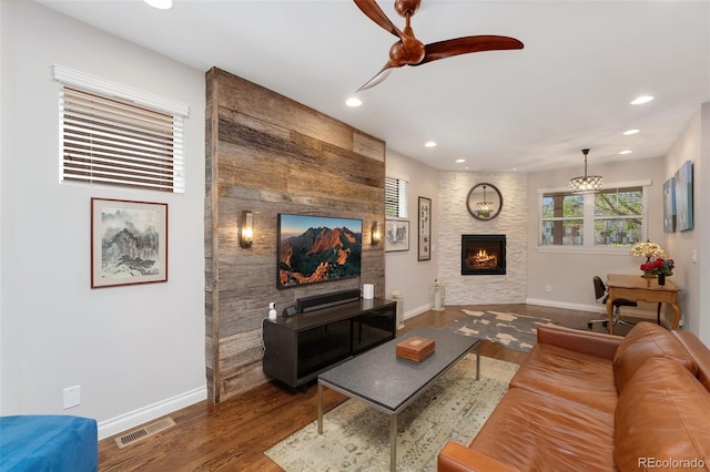living room featuring recessed lighting, visible vents, wood finished floors, and a fireplace