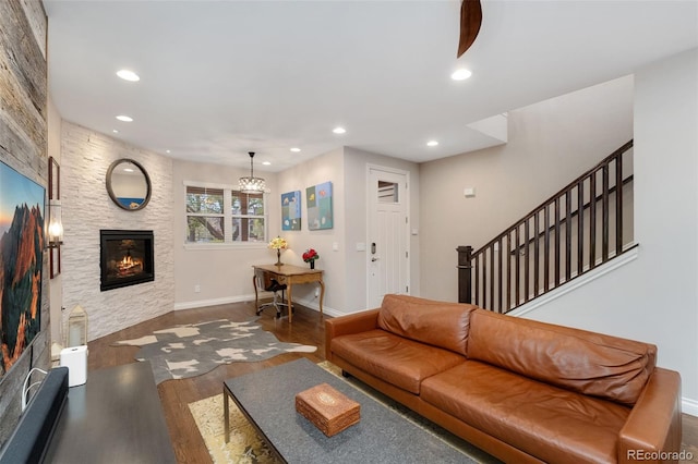 living area featuring recessed lighting, baseboards, wood finished floors, and a fireplace