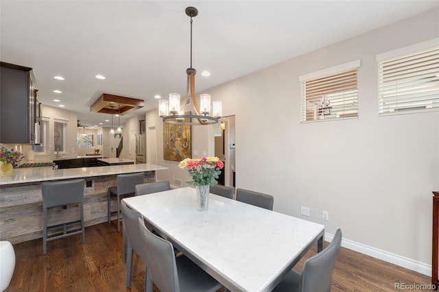 dining room with baseboards, dark wood-type flooring, recessed lighting, and a chandelier
