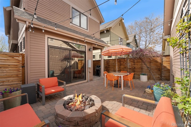 view of patio / terrace featuring grilling area, a fenced backyard, and an outdoor fire pit