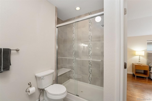 2222 N Washington St, Denver, CO 80205 - bathroom featuring toilet, a shower stall, wood finished floors, and baseboards