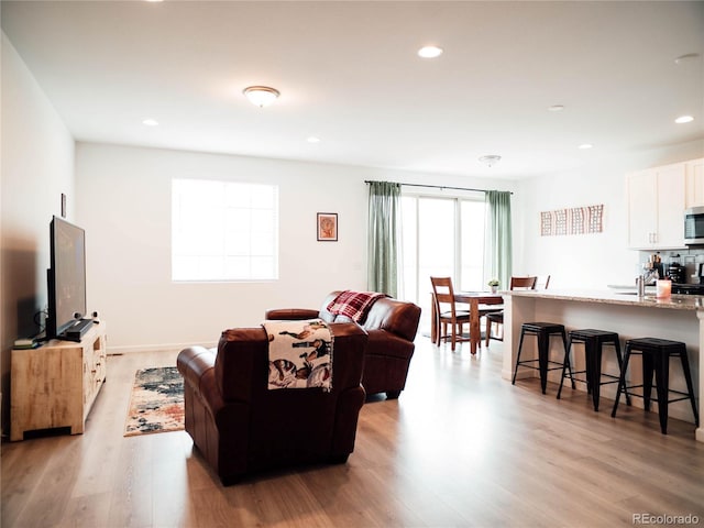 living room featuring recessed lighting and light wood finished floors