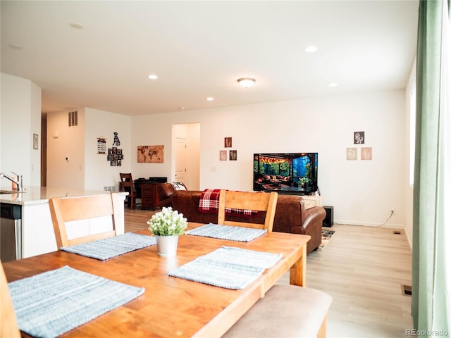 dining area featuring recessed lighting, light wood-type flooring, and visible vents