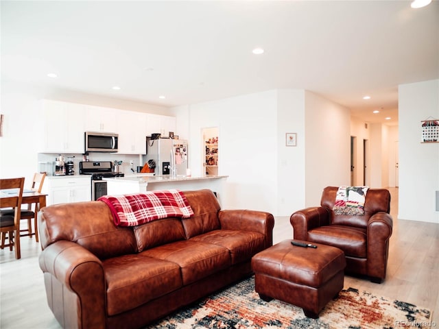 living area with recessed lighting and light wood-type flooring