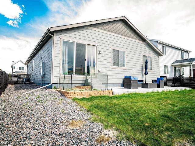 back of house featuring central AC, outdoor lounge area, a fenced backyard, a patio area, and a yard