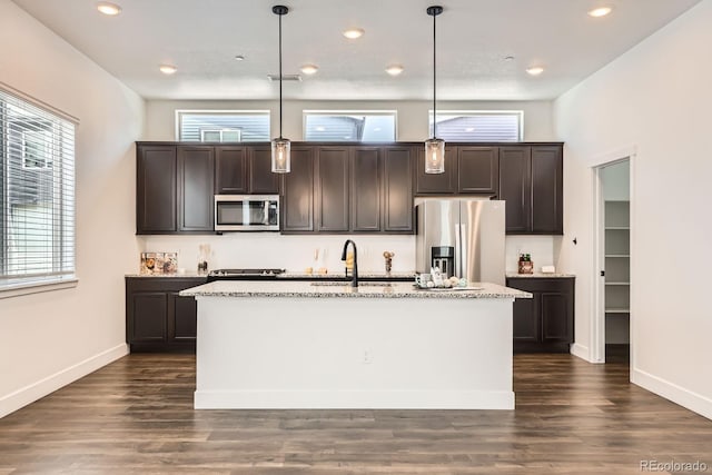 6791 Navajo Ct, Denver, CO 80221 - kitchen with appliances with stainless steel finishes, a sink, dark brown cabinetry, a center island with sink, and recessed lighting