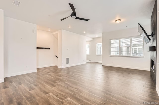 6791 Navajo Ct, Denver, CO 80221 - unfurnished living room featuring ceiling fan, a tile fireplace, wood finished floors, recessed lighting, and baseboards