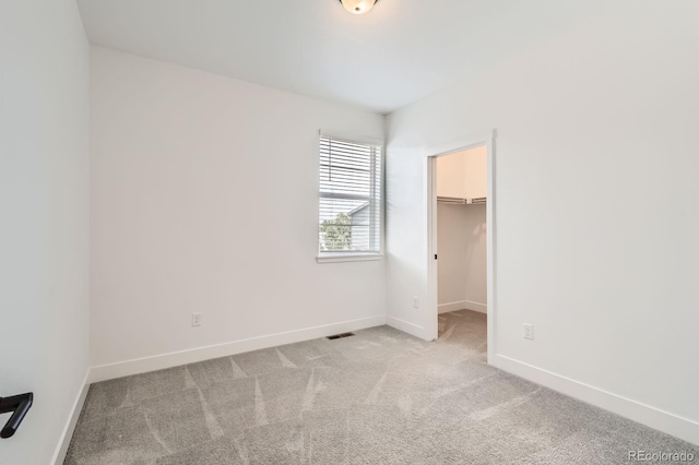 6791 Navajo Ct, Denver, CO 80221 - unfurnished bedroom featuring carpet floors, baseboards, and a walk in closet