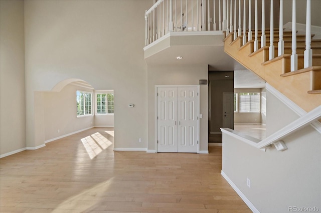 9602 Indian Wells Dr, Lone Tree, CO 80124 - entryway featuring a high ceiling, wood finished floors, baseboards, stairway, and arched walkways