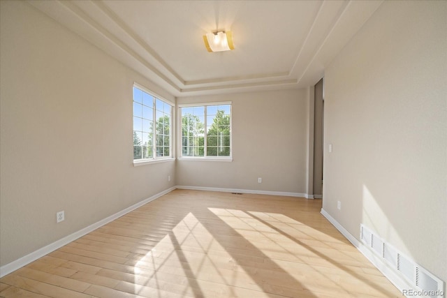 9602 Indian Wells Dr, Lone Tree, CO 80124 - unfurnished room featuring a tray ceiling, light wood-style floors, and baseboards