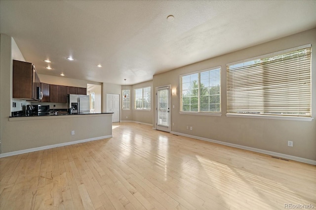 9602 Indian Wells Dr, Lone Tree, CO 80124 - unfurnished living room featuring baseboards, light wood-style flooring, and recessed lighting