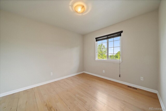 9602 Indian Wells Dr, Lone Tree, CO 80124 - unfurnished room with baseboards and light wood-type flooring