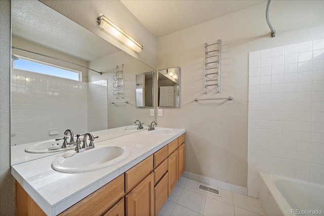9602 Indian Wells Dr, Lone Tree, CO 80124 - bathroom with double vanity, tile patterned floors, and shower / washtub combination
