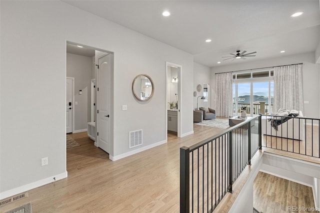 hallway with light hardwood / wood-style floors