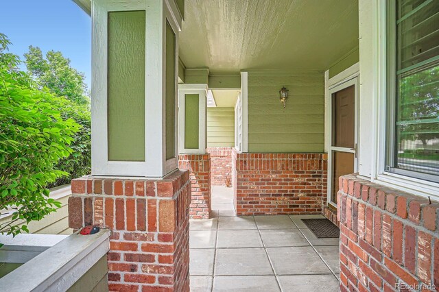 1851 S Marshall Cir, Lakewood, CO 80232 - doorway to property with a porch and brick siding