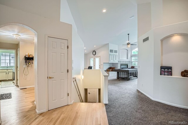1851 S Marshall Cir, Lakewood, CO 80232 - corridor with high vaulted ceiling, arched walkways, baseboards, recessed lighting, and light wood-type flooring