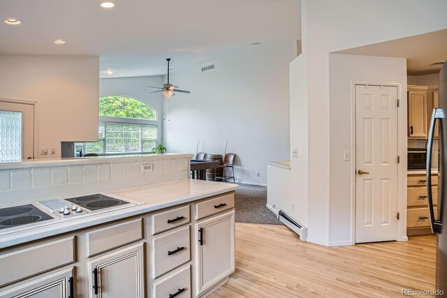1851 S Marshall Cir, Lakewood, CO 80232 - kitchen featuring baseboard heating, ceiling fan, electric cooktop, light wood finished floors, and recessed lighting