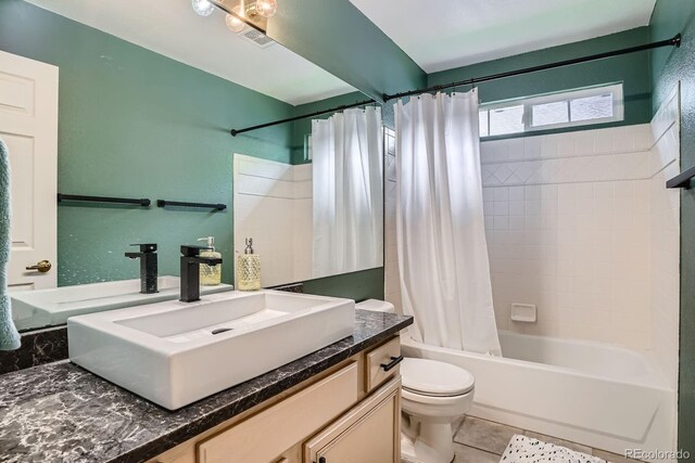 1851 S Marshall Cir, Lakewood, CO 80232 - full bath featuring vanity, toilet, shower / bath combo with shower curtain, and tile patterned flooring