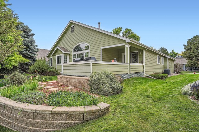 1851 S Marshall Cir, Lakewood, CO 80232 - view of property exterior with a yard and central AC