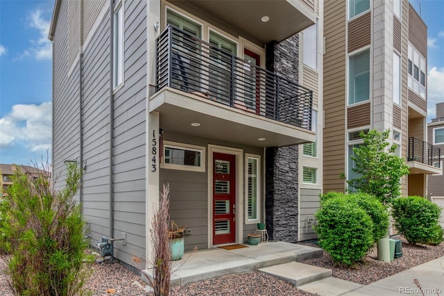 15843 E Broncos Pl, Englewood, CO 80112 - property entrance with a balcony and stone siding