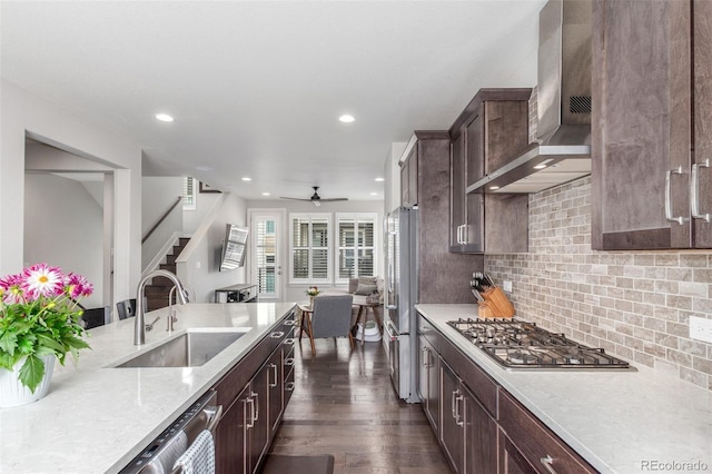 15843 E Broncos Pl, Englewood, CO 80112 - kitchen with a sink, stainless steel appliances, wall chimney range hood, dark wood finished floors, and recessed lighting