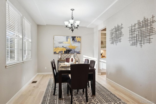 dining area with a notable chandelier and wood-type flooring