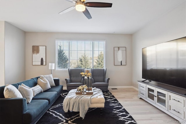 living room with light hardwood / wood-style floors and ceiling fan