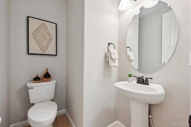 bathroom featuring sink, hardwood / wood-style flooring, and toilet