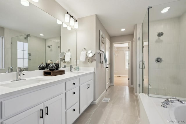 bathroom with tile patterned flooring, plus walk in shower, and vanity