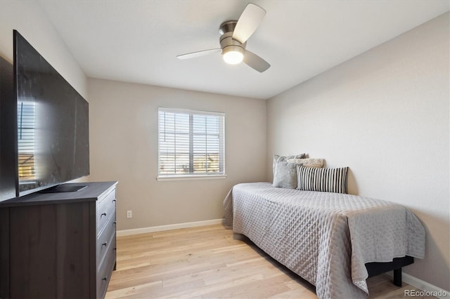 bedroom with ceiling fan and light hardwood / wood-style flooring