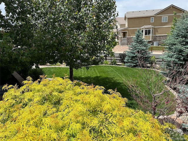 view of property's community with a yard and a patio