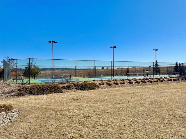 view of home's community featuring tennis court