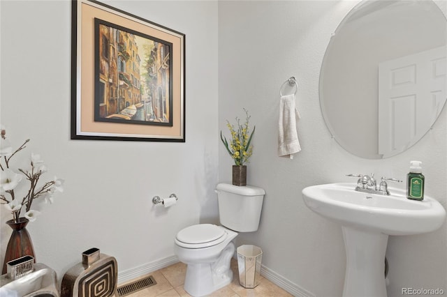 bathroom featuring tile patterned flooring, toilet, and sink