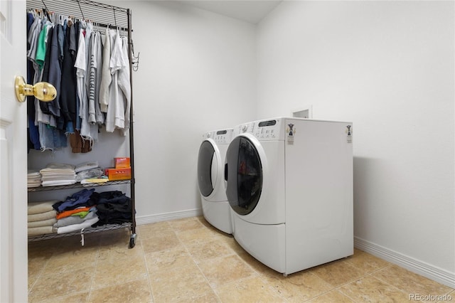 clothes washing area with washing machine and dryer