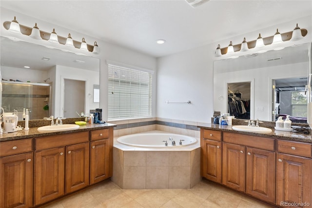 6470 S Ider St, Aurora, CO 80016 - bathroom with tile patterned floors, a stall shower, two vanities, and a garden tub