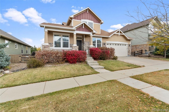 craftsman house featuring a garage and a front lawn