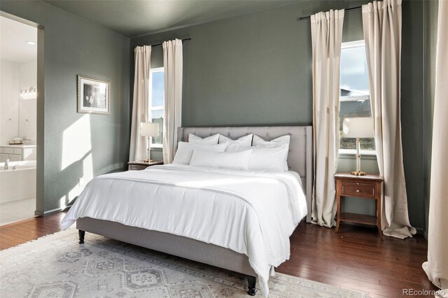 5693 Missoula Trl, Castle Rock, CO 80108 - bedroom with wood-type flooring, multiple windows, and ensuite bath