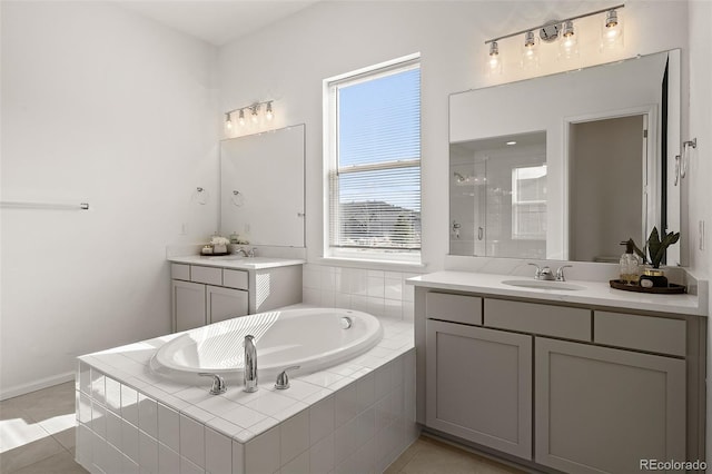 5693 Missoula Trl, Castle Rock, CO 80108 - full bath featuring a stall shower, a bath, two vanities, and tile patterned floors