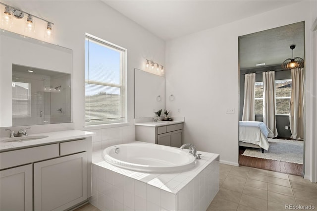 5693 Missoula Trl, Castle Rock, CO 80108 - bathroom with two vanities, a garden tub, healthy amount of natural light, and tile patterned floors