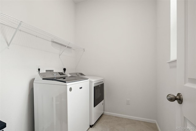 5693 Missoula Trl, Castle Rock, CO 80108 - laundry room featuring washing machine and clothes dryer and light tile patterned floors