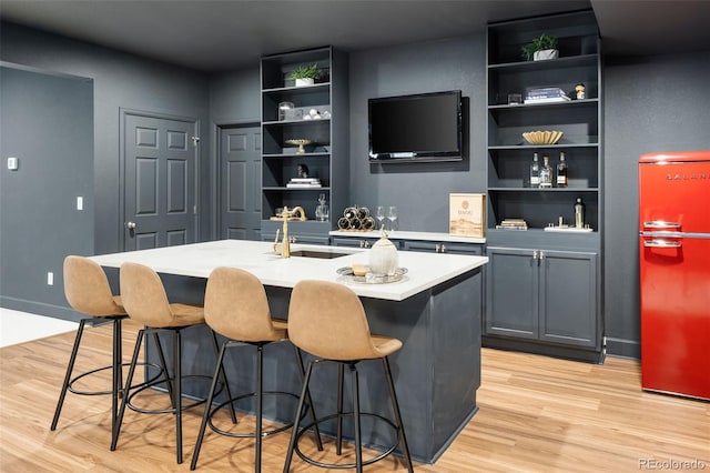 5693 Missoula Trl, Castle Rock, CO 80108 - bar area with light wood-type flooring and refrigerator